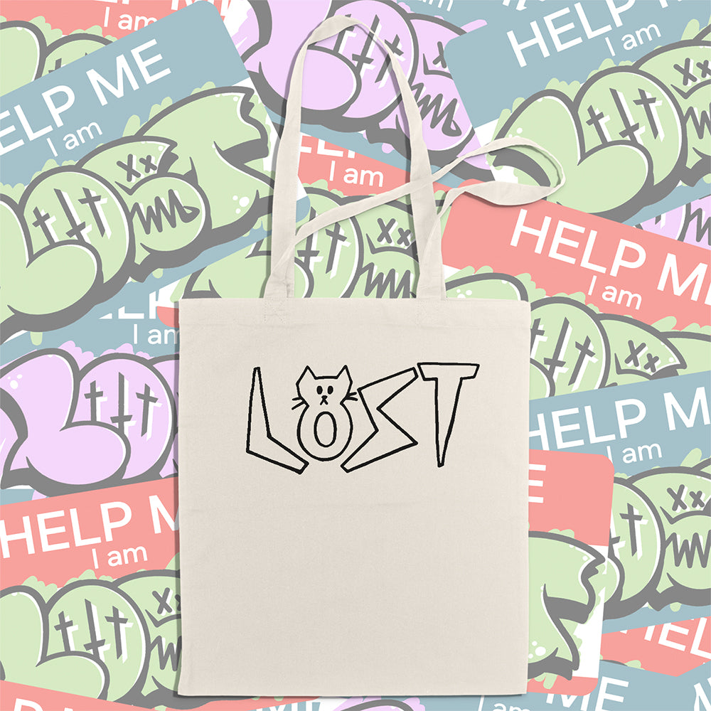 Cat shaped spell out the word LOST across a large tote bag. Hand drawn my my daughter Charlotte and printed in black on natural canvas tote bags. An assortment of colorful graffiti stickers makes up the display background.